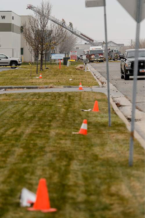 Trent Nelson  |  The Salt Lake Tribune
Cones mark large pieces of debris on the ground nearly a block away from the scene of a helicopter crash at 500 West 900 North in North Salt Lake, Tuesday December 2, 2014.