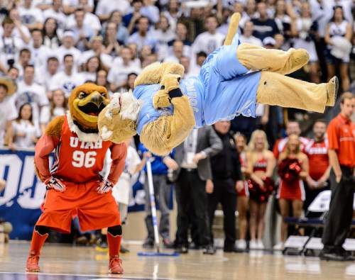 Trent Nelson  |  The Salt Lake Tribune
BYU mascot Cosmo and Utah mascot Swoop compete in a dance-off, as BYU hosts Utah, college basketball at the Marriott Center in Provo, Wednesday December 10, 2014.