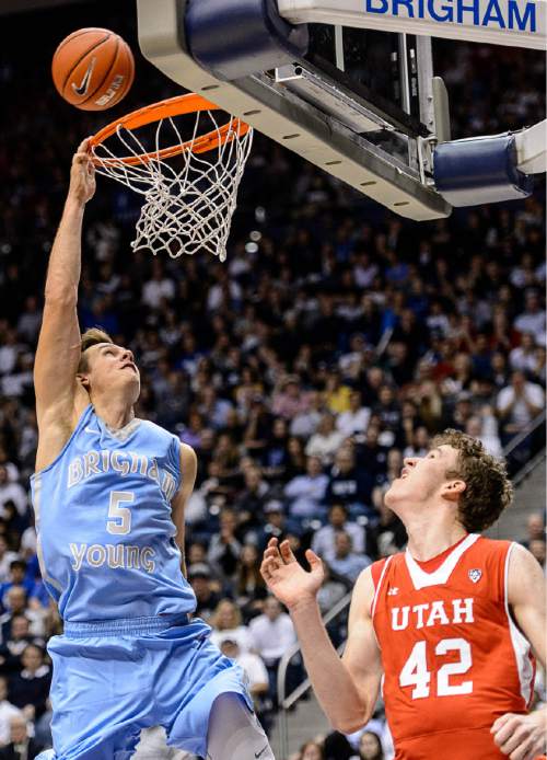 Trent Nelson  |  The Salt Lake Tribune
Brigham Young Cougars guard Kyle Collinsworth (5) goes in for a dunk over Utah Utes forward Jakob Poeltl (42), but missed, as BYU hosts Utah, college basketball at the Marriott Center in Provo, Wednesday December 10, 2014.