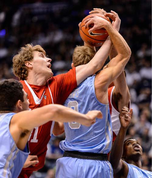 Trent Nelson  |  The Salt Lake Tribune
Utah Utes center Dallin Bachynski (31) fouls Brigham Young Cougars guard Tyler Haws (3) as BYU hosts Utah, college basketball at the Marriott Center in Provo, Wednesday December 10, 2014.