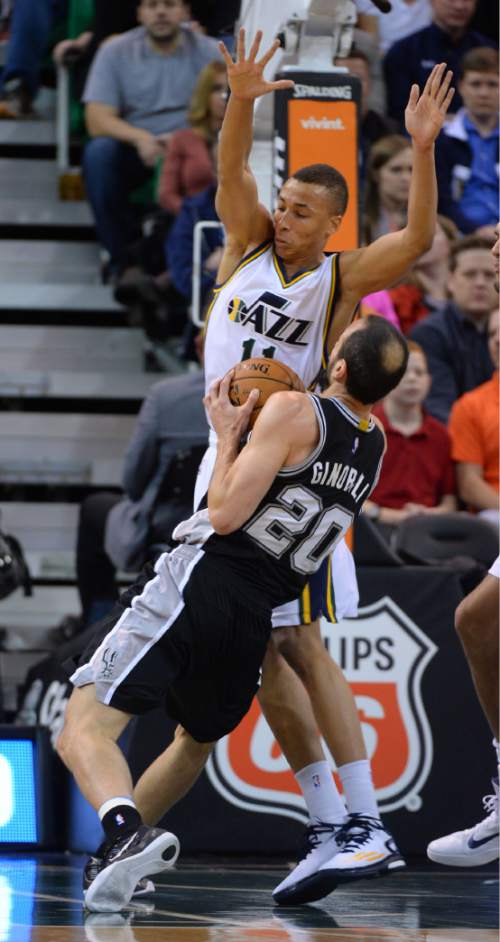 Steve Griffin  |  The Salt Lake Tribune

Utah Jazz guard Dante Exum (11) forces San Antonio Spurs guard Manu Ginobili (20) to change his host during first half action in the Jazz versus Spurs game at EnergySolutions Arena in Salt Lake City, Tuesday, December 9, 2014.