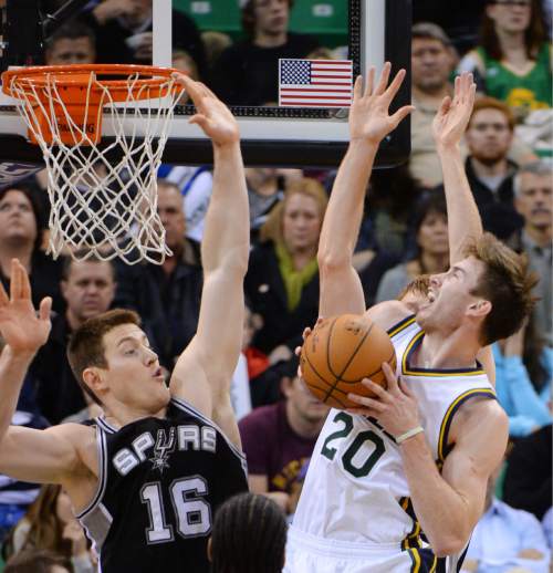 Steve Griffin  |  The Salt Lake Tribune

Utah Jazz forward Gordon Hayward (20) drives into San Antonio Spurs forward Aron Baynes (16) as he draws a foul during second half action in the Jazz versus Spurs game at EnergySolutions Arena in Salt Lake City, Tuesday, December 9, 2014.