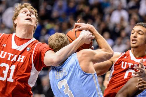 Trent Nelson  |  The Salt Lake Tribune
Utah Utes center Dallin Bachynski (31) fouls Brigham Young Cougars guard Tyler Haws (3) as BYU hosts Utah, college basketball at the Marriott Center in Provo, Wednesday December 10, 2014.