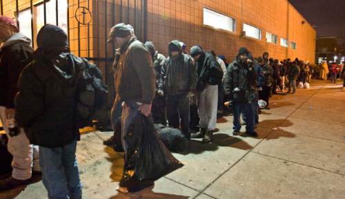 Men stand in line on Monday, February 4, 2008 at the Road Home  shelter on Rio Grande St. waiting to get in there or be bused to the overflow shelter in Midvale for the night.  
Paul Fraughton /The Salt Lake Tribune; 2/4/08