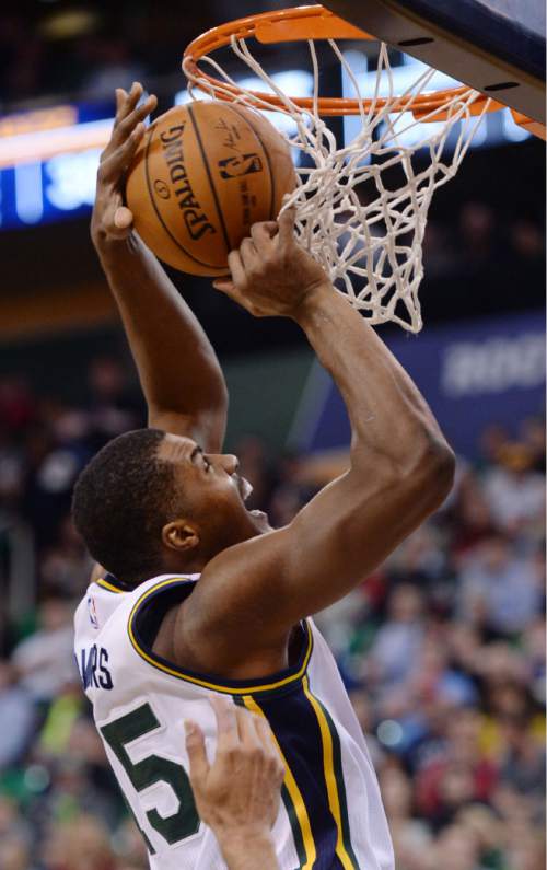 Steve Griffin  |  The Salt Lake Tribune

Utah Jazz forward Derrick Favors (15) gets caught under the basket as he tries to score during first half action in the Jazz versus Spurs game at EnergySolutions Arena in Salt Lake City, Tuesday, December 9, 2014.