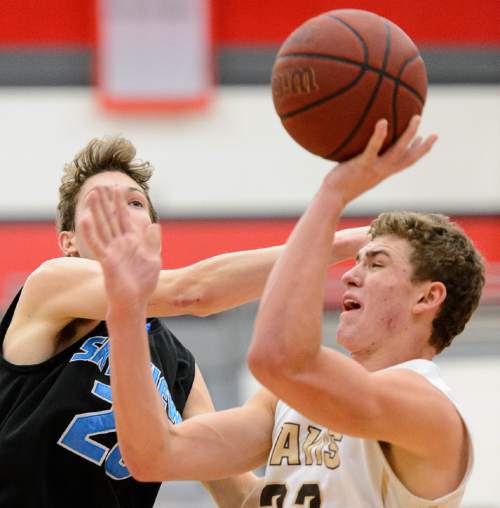 Trent Nelson  |  The Salt Lake Tribune
Davis's Ben Rigby is fouled by Sky View's Jake Hendricks  as Sky View faces Davis High School in the championship game of the Utah Elite 8 basketball tournament in American Fork, Saturday December 13, 2014.
