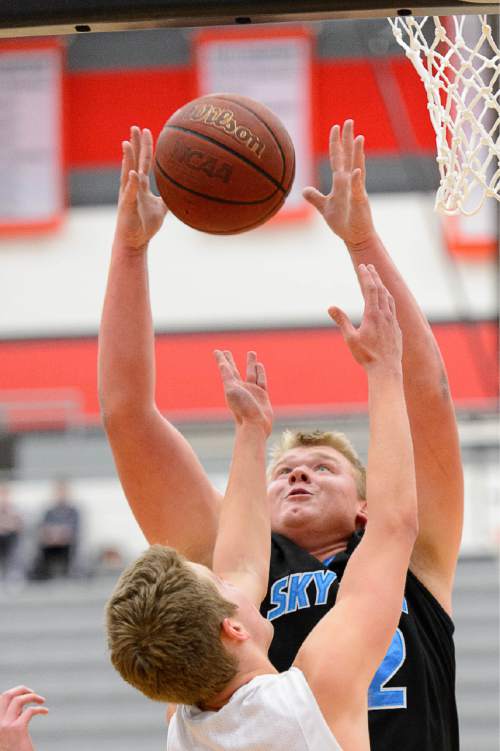 Trent Nelson  |  The Salt Lake Tribune
Sky View's Tyler Downs pulls down a rebound ahead of Davis's Jesse Wade as Sky View faces Davis High School in the championship game of the Utah Elite 8 basketball tournament in American Fork, Saturday December 13, 2014.