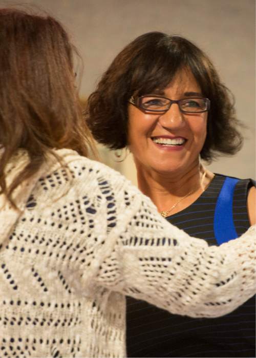 Rick Egan  |  The Salt Lake Tribune

Ghassack Jaffar (left), gives  founder Samira Harnish (right) a hug, after receiving a Certificate of Achievement Award during the 4th Annual Celebration of Women of the World, Saturday, December 13, 2014.