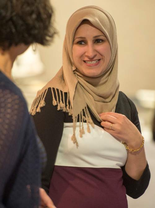 Rick Egan  |  The Salt Lake Tribune

Sara Al-Janabi (right) receives an award from Samira Harnish (left) during the 4th Annual Celebration of Women of the World, Saturday, December 13, 2014