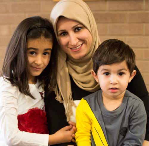 Rick Egan  |  The Salt Lake Tribune

Sara Al-Janabi, a refugee from Bagdad Iraq, received a Certificate of Achievement Award during the 4th Annual Celebration of Women of the World, Saturday, December 13, 2014/ Sara holds her daughter Sedra, 6, and her son Ahmed, 2.