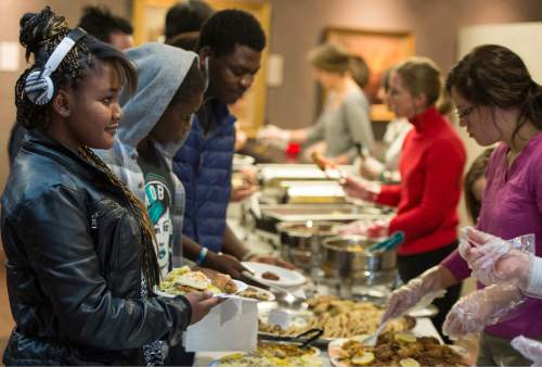 Rick Egan  |  The Salt Lake Tribune

Participants line up for lunch during the 4th Annual Celebration of Women of the World, Saturday, December 13, 2014.