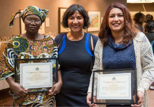 Rick Egan  |  The Salt Lake Tribune

Elisabeth Ngaba,  (left)  founder Samira Harnish (center) and Ghassack Jaffar (right) after receiving their Certificate of Achievement Award during the 4th Annual Celebration of Women of the World,  Saturday, December 13, 2014.