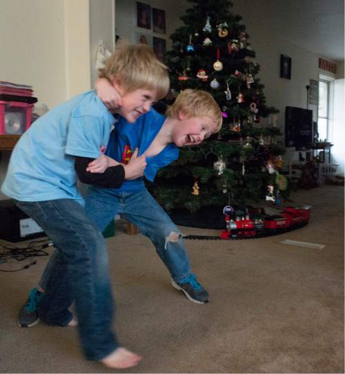 Rick Egan  |  The Salt Lake Tribune
Stryker, 7 wrestles with his little brother Sage, 5, Monday, December 8, 2014. Both boys and their sister Samantha have been receiving Christmas presents through the Prison Fellowship's Angel Tree program, where local churches, businesses and individuals purchase the gifts, which are given to the kids in their parent's name.
