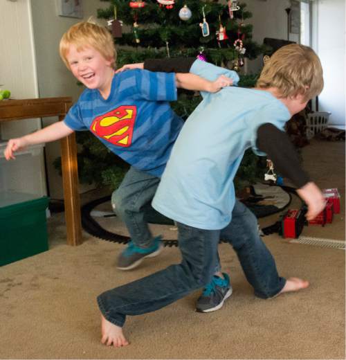 Rick Egan  |  The Salt Lake Tribune

Stryker, 7 wrestles with his little brother Sage, 5, Monday, December 8, 2014. Both boys and their sister Samantha have been receiving Christmas presents through the Prison Fellowship's Angel Tree program, where local churches, businesses and individuals purchase the gifts, which are given to the kids in their parent's name.