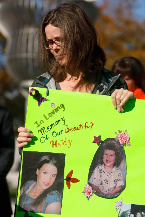 Trent Nelson  |  The Salt Lake Tribune
Autumn Wagner holds a sign memorializing her sister, Heidy Truman, who was killed last year. City officials and community members planted daffodils at the Public Safety Building in Salt Lake City Tuesday, October 15, 2013 in support of YWCA's Week Without Violence.