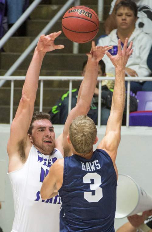 Rick Egan  |  The Salt Lake Tribune

Weber State Wildcats center James Hajek (45) tosses a pass over the top of Brigham Young Cougars guard Tyler Haws (3), in basketball action BYU vs Weber State, at the Dee Events Center in Ogden, Saturday, December 13, 2014