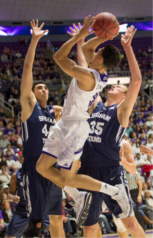 Rick Egan  |  The Salt Lake Tribune

Brigham Young Cougars center Corbin Kaufusi (44) and Brigham Young Cougars forward Isaac Neilson (35) double-team Weber State Wildcats guard Jeremy Senglin (30), in basketball action BYU vs Weber State, at the Dee Events Center in Ogden, Saturday, December 13, 2014
