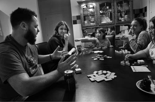 Scott Sommerdorf   |  The Salt Lake Tribune
Bryant Jacobs, his wife Michele, step-daughter Karsyn, sister-in-law Sara and step daughter Lilly play a board game on their kitchen table the night before his amputation surgery, Monday, March 17, 2014.
