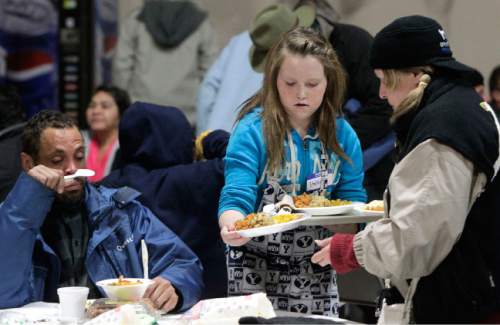 Leah Hogsten  |  Tribune file photo
Stahlie Singleton, 12 at the time of this photo last Christmas, serves dinners to the needy with her family at the Salt Lake City Rescue Mission.