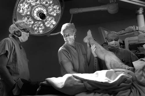 Scott Sommerdorf   |  The Salt Lake Tribune
Surgeon Erik Kubiak examines Bryant Jacobs' right leg at the beginning of Jacobs' amputation surgery at the Salt Lake City VA, Tuesday, March 18, 2014.