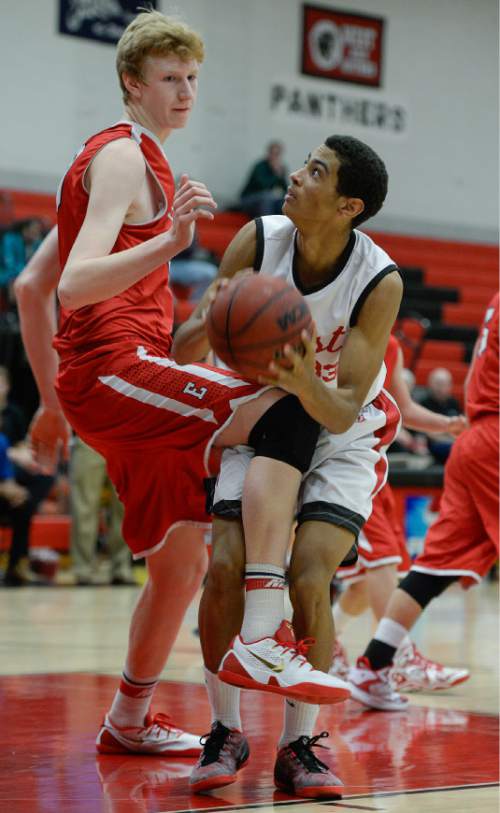 Francisco Kjolseth  |  The Salt Lake Tribune
West High's Justus Murray contends with a knee from Mark Jackson of East High in the Panthers Classic tournament between the two rival schools at West.