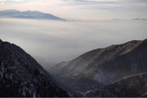 Al Hartmann  |  The Salt Lake Tribune              
View of Salt Lake Valley taken from a high point looking down Millcreek Canyon Wednesday afternoon Dec. 17 shows cold and polluted air settling in.  Tops of the Oquirrh Range across the valley poke out of the layer.