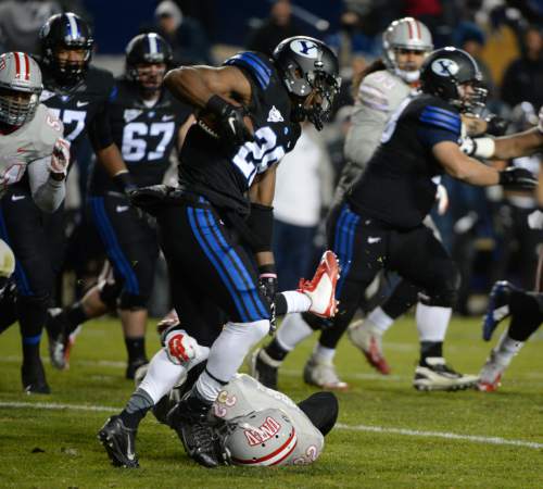 Steve Griffin  |  The Salt Lake Tribune

Brigham Young Cougars running back Adam Hine (28) gets tripped up by UNLV Rebels defensive back Mike Horsey (32) during second half action in the BYU versus UNLV football game at LaVell Edwards Stadium in Provo, Saturday, November 15, 2014.