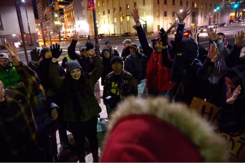Leah Hogsten  |  The Salt Lake Tribune
All hands went up from protesters when asked who wanted to stop traffic prior to their march. Traffic throughout Salt Lake City's streets came to a halt Friday, December 19, 2014 as 40 some protesters with Activist's Corner walked on city streets chanting and holding signs against police brutality during their Merry X - Mas! Shut It Down march. 
The group started outside the Salt Lake City Federal Building, marched down State Street to 600 South and then stopped traffic on both the I-15 on-ramp and the 500 South off ramp in solidarity with the national  movements against violent criminal police.