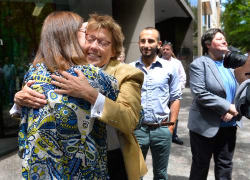 Scott Sommerdorf   |  The Salt Lake Tribune
Attorney Peggy Tomsic hugs a friend as she walks to a press conference where she commented on the ruling from the 10th Circuit on Wednesday, June 25, 2014. Two of her clients, Moudi Sbeity, and Kate Call follow her at right. Tomsic said: "[The ruling affirms the fundamental principles of equality and fairness and the common humanity of gay and lesbian people."
