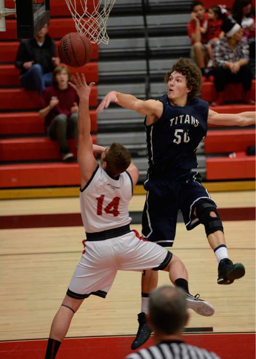 Scott Sommerdorf   |  The Salt Lake Tribune
Syracuse's Kalvin Mudrow blocks a shot by West's Riley Kenner during second half play. Syracuse beat West 52-51 at the West High Holiday Classic Tournament, Friday, December 19, 2014.