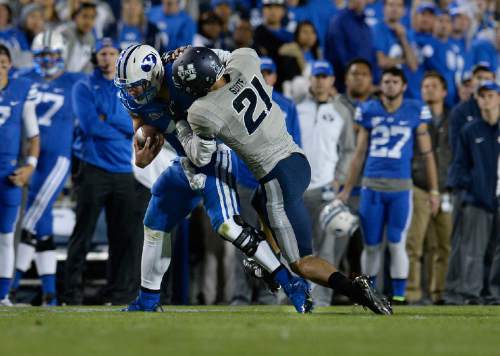 Scott Sommerdorf  |  The Salt Lake Tribune
BYU QB Taysom Hill was injured and left the game after this tackle by Utah State Aggies safety Brian Suite (21) late in the second quarter. Utah State led BYU 28-14 at the half in Provo, Friday, October 1, 2014.