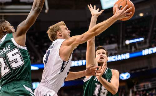 Trent Nelson  |  The Salt Lake Tribune
Brigham Young Cougars guard Tyler Haws (3) drives to the basket, defended by Hawaii Warriors forward Mike Thomas (25) and Stefan Jovanovic (15) as BYU faces Hawaii, college basketball at EnergySolutions Arena in Salt Lake City, Saturday December 6, 2014.