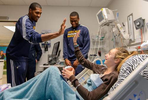 Trent Nelson  |  The Salt Lake Tribune
Kimberly Knudson got high-fives from Utah Jazz players Derrick Favors and Alec Burks during a visit by Jazz players to Primary Childrenís Medical Center in Salt Lake City last week.
