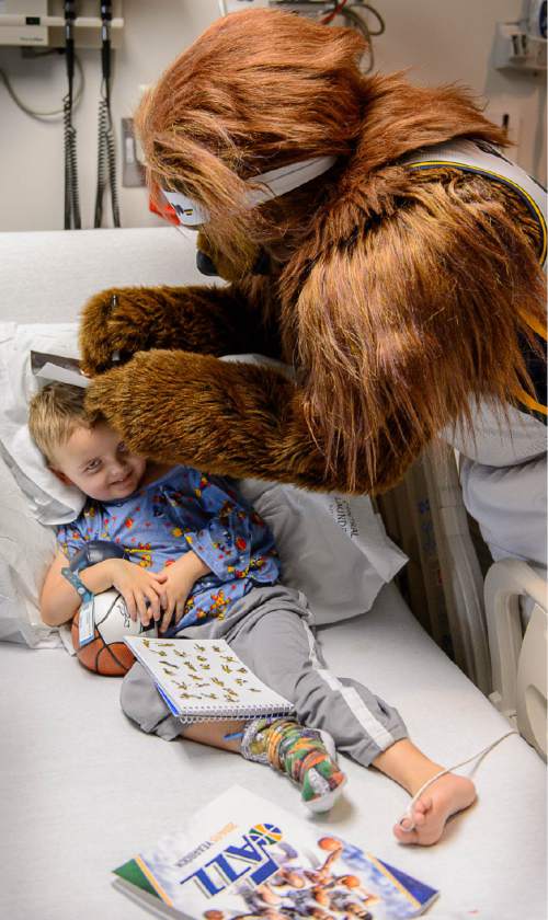 Trent Nelson  |  The Salt Lake Tribune
Bear, the mascot of the Utah Jazz, autographs a photo for 4-year-old Beckham Hendrix during a visit by Jazz players to Primary Children's Medical Center in Salt Lake City, Thursday December 11, 2014.