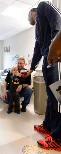 Trent Nelson  |  The Salt Lake Tribune
Utah Jazz guard Alec Burks hands an autographed ball to 3-year-old Robert De Angelis during a visit by Jazz players to Primary Childrenís Medical Center in Salt Lake City last week. Robert's father, Mike De Angelis at center.