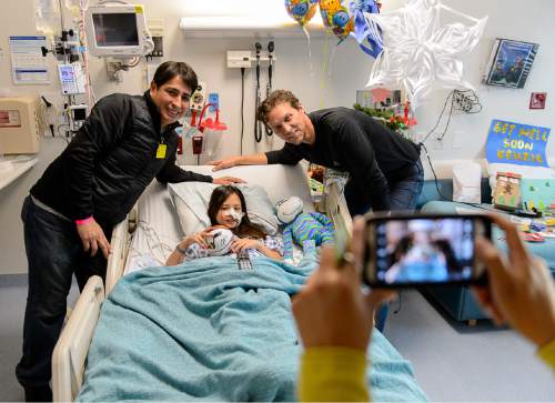 Trent Nelson  |  The Salt Lake Tribune
Utah Jazz coach Quin Snyder, right poses for a photo with Mackenzie Espinoza and her father Ruben Espinoza during a visit by Jazz players to Primary Children's Medical Center in Salt Lake City, Thursday December 11, 2014.