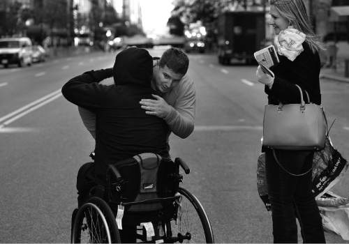 Scott Sommerdorf   |  The Salt Lake Tribune
Bryant Jacobs gets a hug from Travis Wood after he met his goal by finishing the New York City Marathon in a hand cycle, Sunday, November 2, 2014.