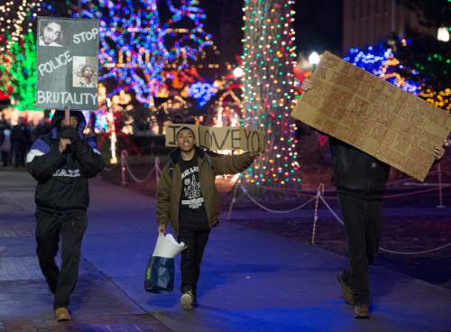 Rick Egan  |  The Salt Lake Tribune

A group of people march down the sidewalk along Washington Blvd, as they chant against police violence, Saturday, December 20, 2014