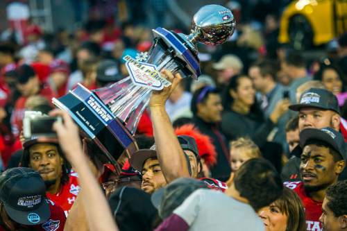 Chris Detrick  |  The Salt Lake Tribune
Utah Utes tight end Westlee Tonga (80) holds up the trophy as he celebrates with fans and teammates after winning the Royal Purple Las Vegas Bowl at Sam Boyd Stadium Saturday December 20, 2014. Utah defeated Colorado State 45-10.