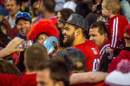 Chris Detrick  |  The Salt Lake Tribune
Utah Utes tight end Westlee Tonga (80) holds the trophy as he celebrates with fans and teammates after winning the Royal Purple Las Vegas Bowl at Sam Boyd Stadium Saturday December 20, 2014. Utah defeated Colorado State 45-10.