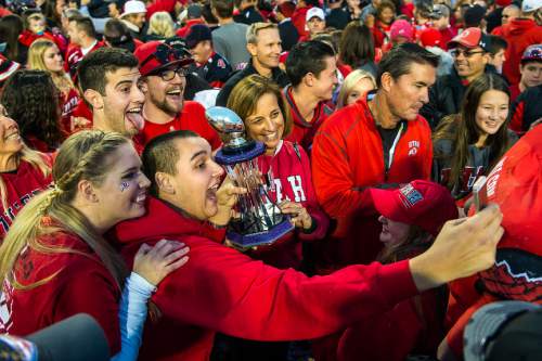 Chris Detrick  |  The Salt Lake Tribune
Friends and family members of Travis Wilson poses for a selfie with his MVP trophy after winning the Royal Purple Las Vegas Bowl at Sam Boyd Stadium Saturday December 20, 2014. Utah defeated Colorado State 45-10.