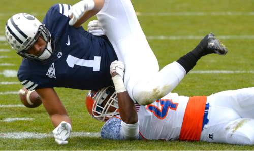 Leah Hogsten  |  The Salt Lake Tribune
Brigham Young Cougars wide receiver Ross Apo (1) fumbles a catch and tackled by Savannah State Tigers cornerback John Wilson (4). Brigham Young University leads Savannah State 51-0 at the half, November 22, 2014, at LaVell Edwards Stadium in Provo.