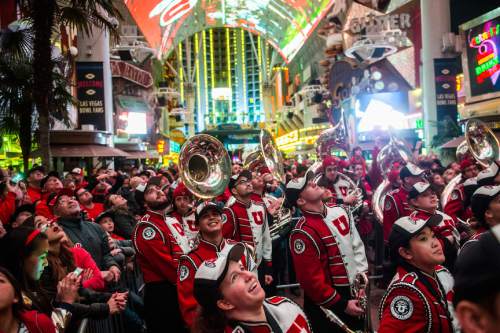 Chris Detrick  |  The Salt Lake Tribune
Members of the Marching Utes band and Utah fans watch highlights of the football team on the overhead screen during the Fremont Street Experience Pep Rally in Las Vegas Friday December 19, 2014.