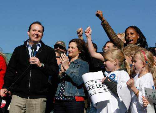 Scott Sommerdorf   |  Tribune file photo
Sen. Mike Lee, with his wife Sharon standing next to him, and Mia Love at the far right, showing enthusiastic support, at a rally in South Jordan, Utah, soon after the government shutdown that sent his approval rating plummeting. It was an image that Democrats would use against her in the 2014 campaign.