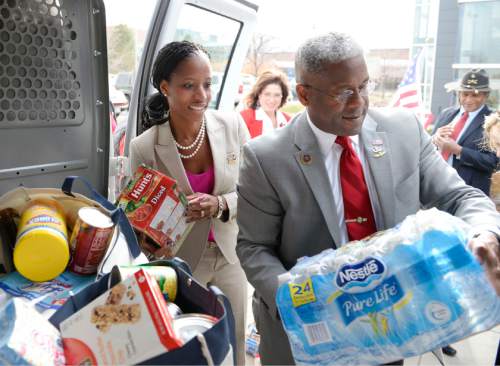 Al Hartmann  |  Tribune file photo
Mia Love and former Congressman Allen West -- a luminary of the tea-party movement, load donated food items to a veterans care center. The two appeared earlier in the day at a town hall meeting.