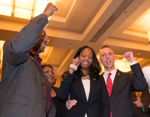 Steve Griffin  |  The Salt Lake Tribune


Mia Love pumps her fist with her husband, Jason, right, and her father, Maxime Bourdeau, as she is introduced as the winner of her congressional race in Utah's 4th district  Salt Lake City, Wednesday, November 5, 2014.