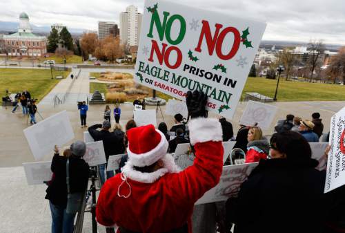 Francisco Kjolseth  |  The Salt Lake Tribune
Richard Richey from Saratoga Springs dressed as Santa as he joins the five community groups opposing the prison relocation for a mass protest at noon, on the south steps of the Utah Capitol on Monday, Dec. 22, 2014, two hours before the Prison Relocation Commission meeting.
