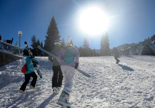Al Hartmann  |  The Salt Lake Tribune
Skiers and snowboarders climb slope to the lift under blue sky and fresh snow at Brighton Ski Resort Tuesday Dec. 23.  The holiday ski season really got underway with school out and new snow from the weekend storms.