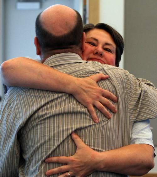 Rick Egan  | The Salt Lake Tribune 

Clyde Patton gets a hug from Kate Call, during the Restore Our Humanity  press conferenceThursday, June 27, 2013.