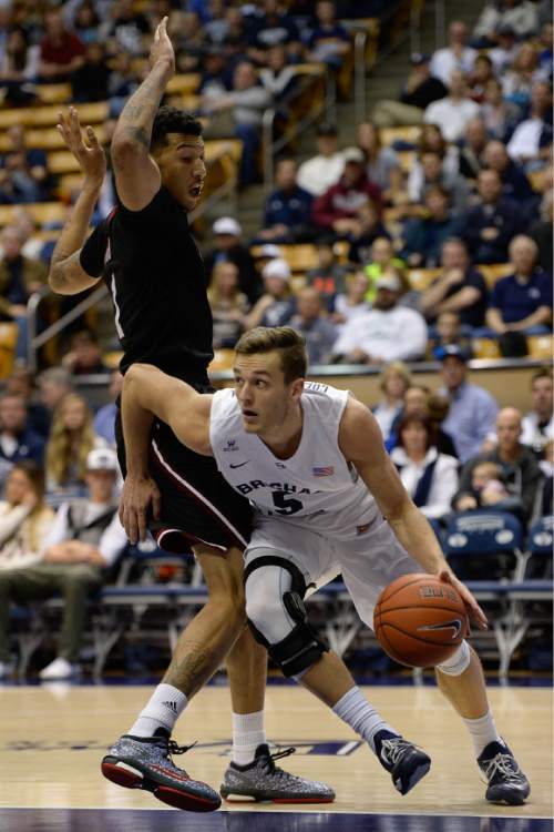 Francisco Kjolseth  |  The Salt Lake Tribune
BYU's Kyle Collinsworth moves around Maxie Esho of UMass in game action at the Marriott Center in Provo on Tuesday, Dec. 23, 2014.